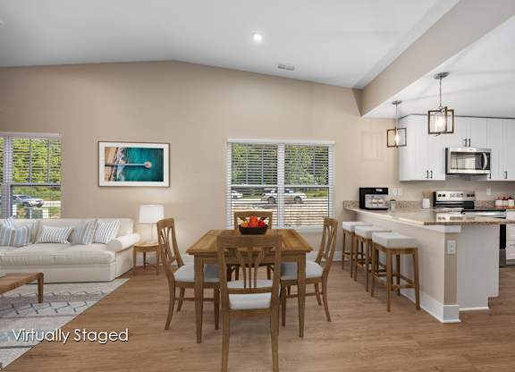 A kitchen with a table and chairs in the middle of the room.
