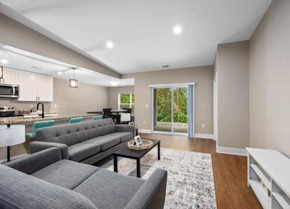 A modern living room with grey couches and a coffee table.