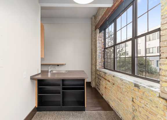 A kitchen with a sink and a window.