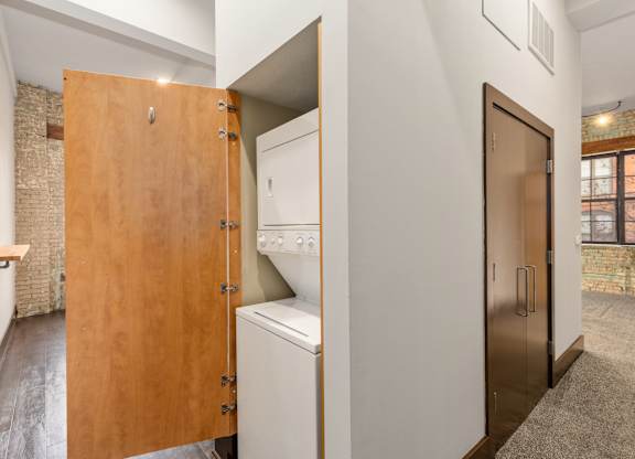 A kitchen with a wooden door and a white oven.