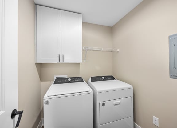 A small laundry room with a washer and dryer.