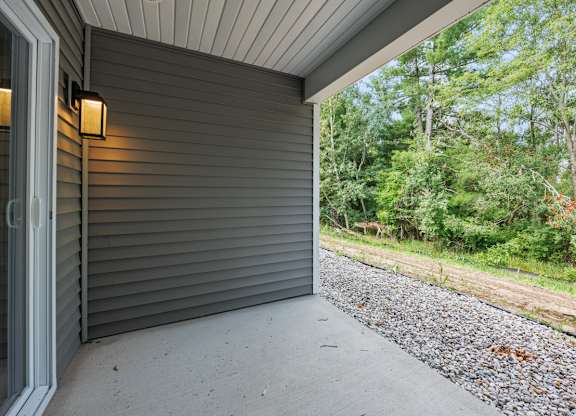 A grey house with a grey wall and a grey floor.