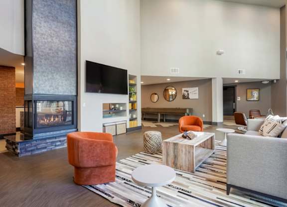 A modern living room with a fireplace and a TV.