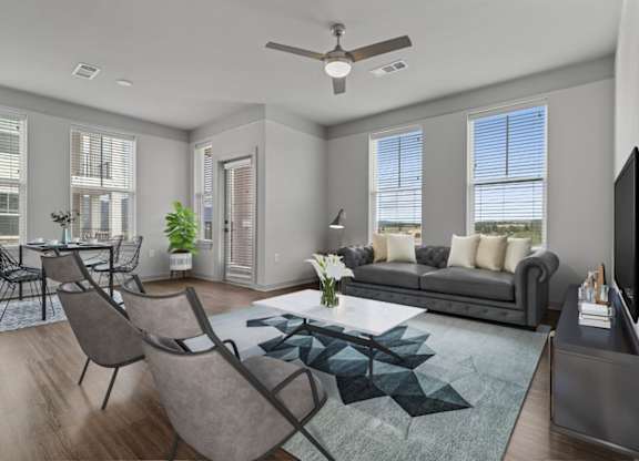 A modern living room with a grey sofa, a coffee table, and a television.