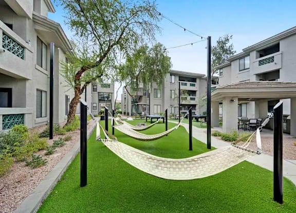 A grassy area with a white pathway and black poles.