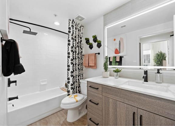 A bathroom with a toilet, sink, and shower.