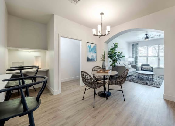 a dining room and living room with a table and chairs