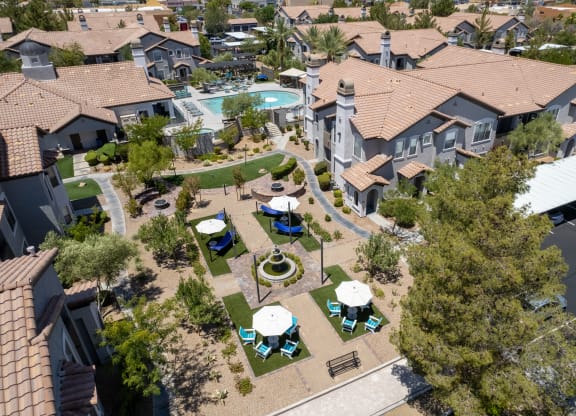 an aerial view of a neighborhood with houses and a swimming pool