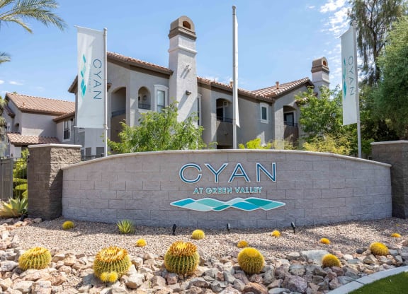 the cyan at green valley apartments sign in front of the building