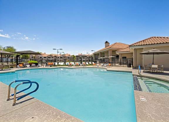 A large swimming pool with a blue tinted water and a white sign on the ground.