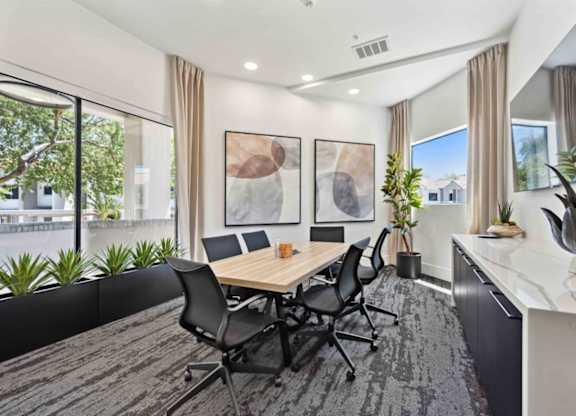 A conference room with a long table and chairs.