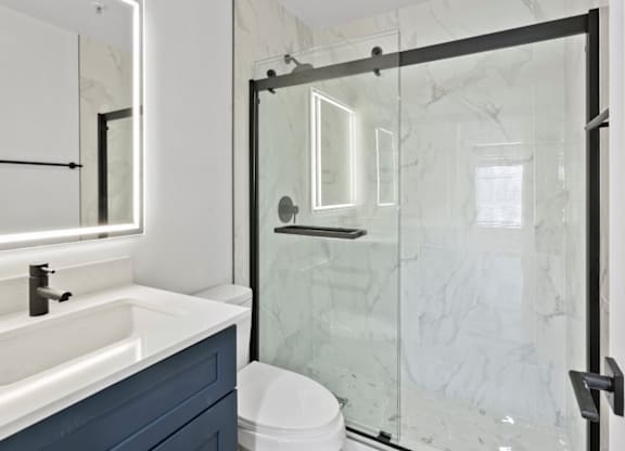 A white sink with a black faucet in a bathroom.