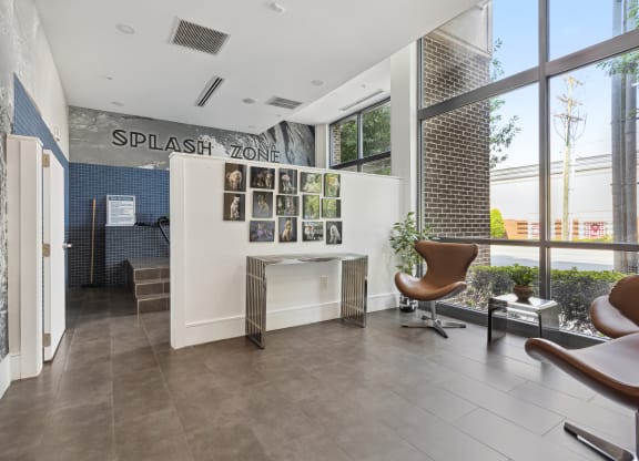 an office with a large window and a desk with a chair