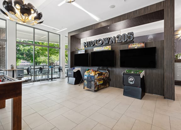 a view of the lobby at midtown 206 with a variety of games on the wall and