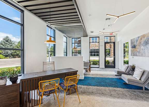 A modern living room with a dining table and chairs.