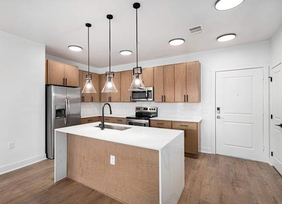A kitchen with wooden cabinets and a white countertop.