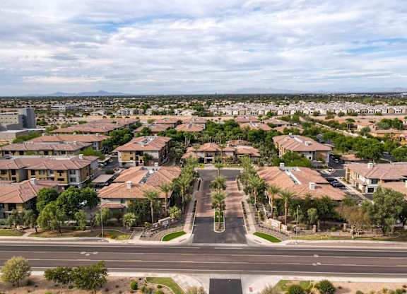 A suburban neighborhood with houses and palm trees.