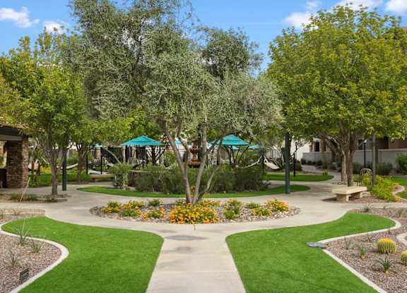 A garden with a circular flower bed in the center and a walking path around it.