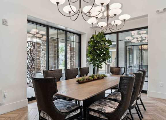 A dining room with a wooden table and chairs.
