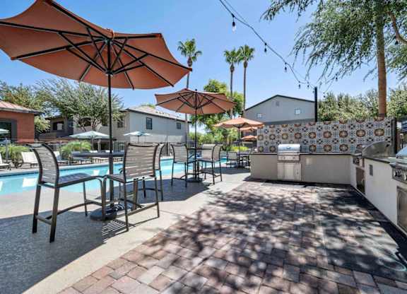 A poolside area with umbrellas and chairs.