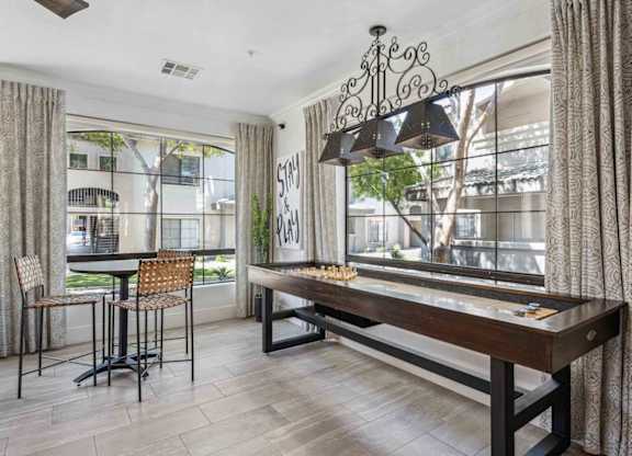 A dining room with a wooden table and chairs.
