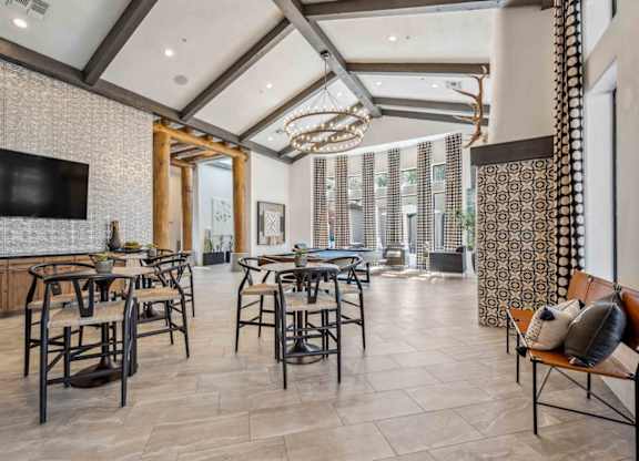 A modern dining room with a large table and chairs.