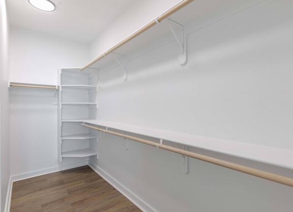 A white refrigerator with a wooden shelf below it.