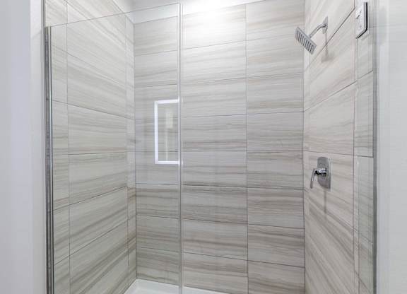 A modern bathroom with a glass shower stall.