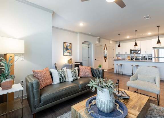 A living room with a grey couch and a wooden coffee table.