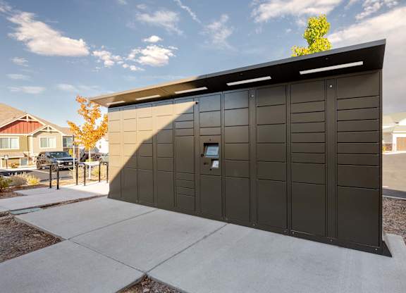 A black building with a tree in front of it.