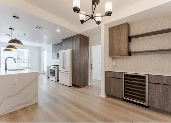 A modern kitchen with a refrigerator, oven, and a countertop.