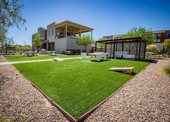 A modern house with a green lawn in front.