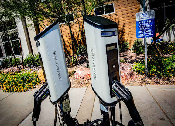Two electric vehicle charging stations are located outside a building.