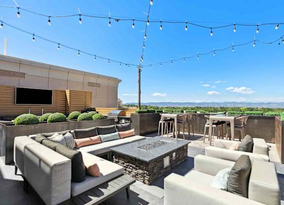 an outdoor patio with couches and a firepit