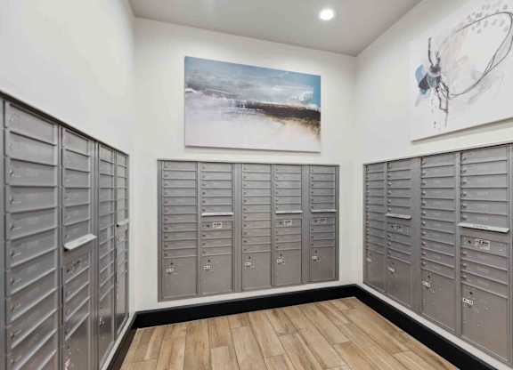 a large number of lockers in a room with a painting on the wall