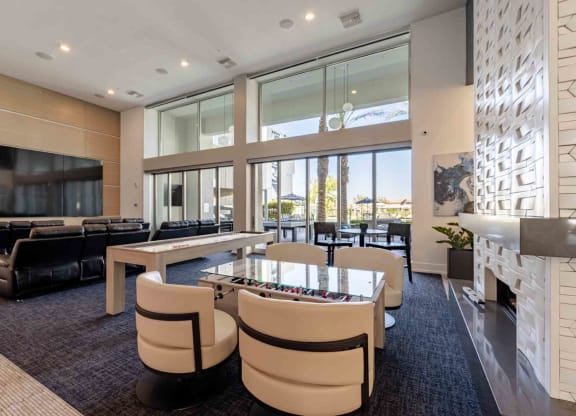 a game room with a foosball table and chairs