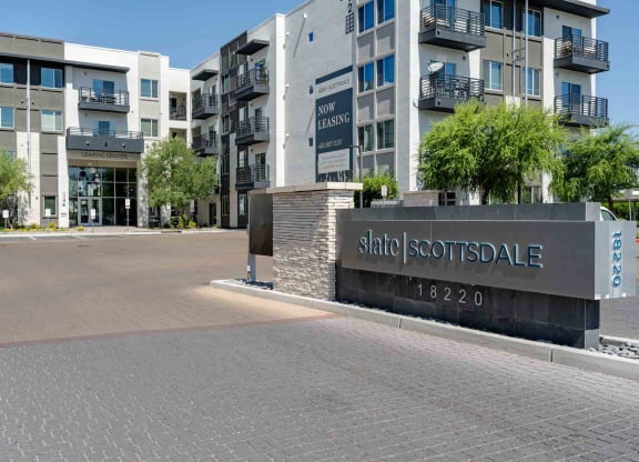 a view of the main entrance to slate scottsdale apartments in the background