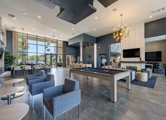 a spacious lobby with a pool table and lounge area