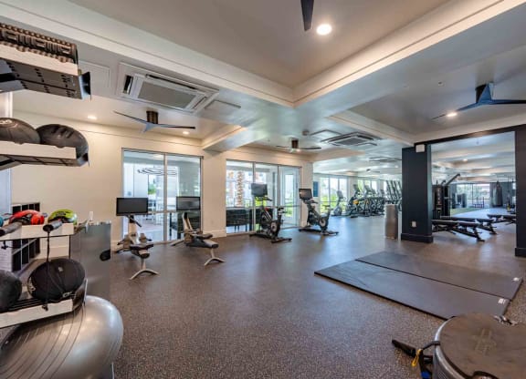 a spacious fitness center with cardio equipment and weights at slate scottsdale apartments in arizona