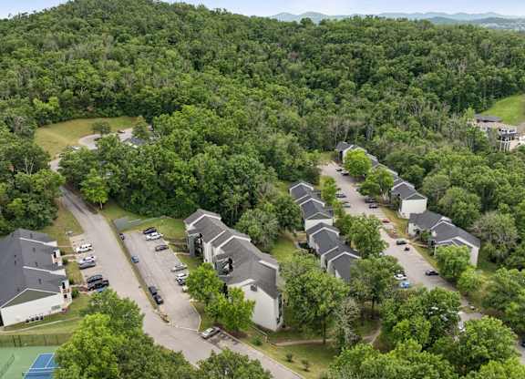 A bird's eye view of a residential area with houses and cars.