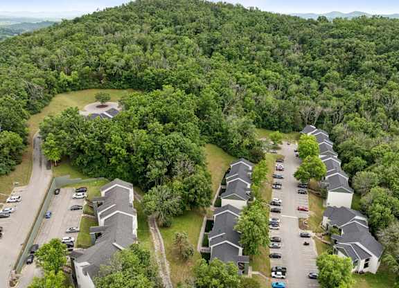 A bird's eye view of a residential area with houses and cars.