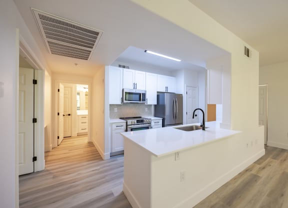 a kitchen with white cabinets and a white counter top