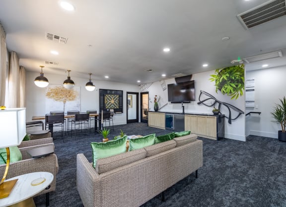 an open concept living room with a kitchen and dining area