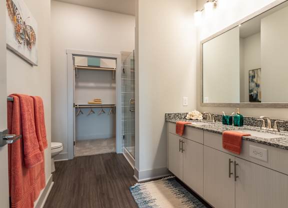 A bathroom with a sink, mirror, and towel rack.