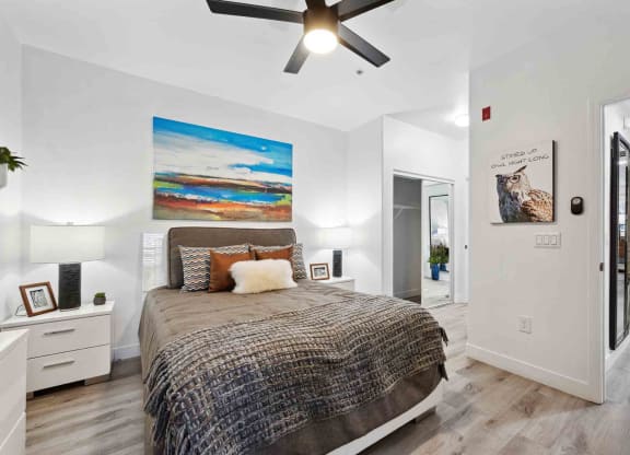 a bedroom with a bed and a ceiling fan