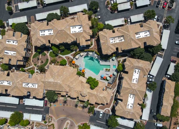 arial view of a large mansion with a swimming pool in the middle of it