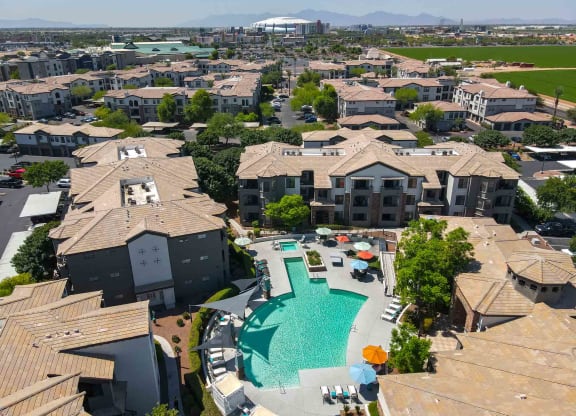 an aerial view of a community with a large swimming pool in the middle of it