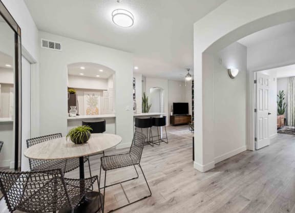 a dining area with a round table and four chairs