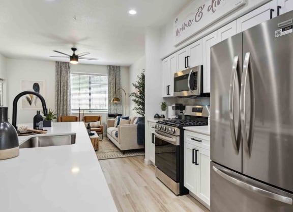 a kitchen with a refrigerator freezer and a stove top oven