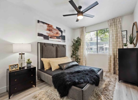 a bedroom with a large bed and a ceiling fan